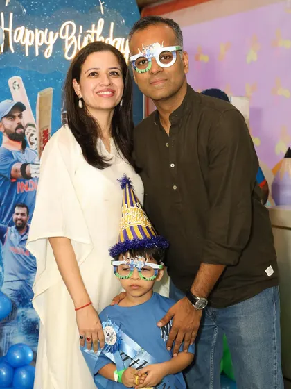A lovely family portrait at a cricket-themed birthday celebration.