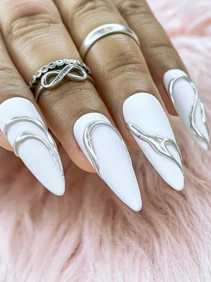 Another perspective of the white and silver nails, highlighting the contrast between the matte base and the high-shine chrome.