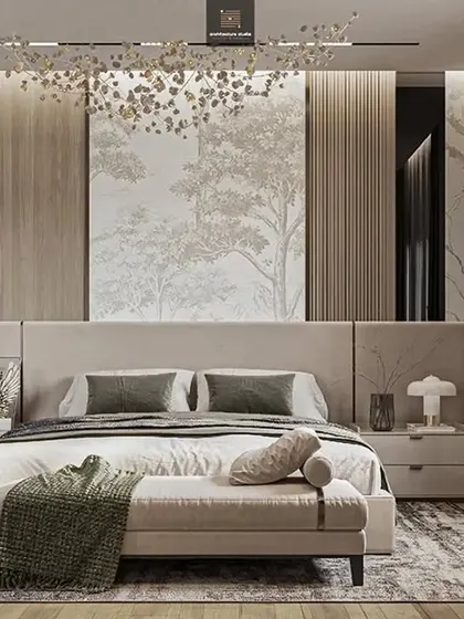 A serene bedroom with a nature-inspired wallpaper behind the bed. The neutral color palette, plush bench, and beautiful chandelier create a calm and relaxing retreat.