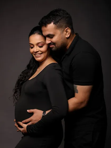 A tender and serene moment, with both partners gently holding the baby bump.