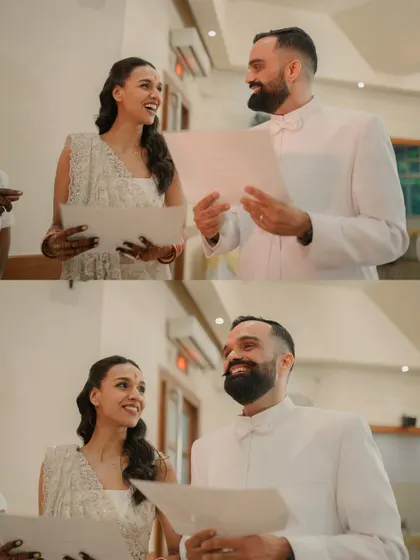 Reading their vows or perhaps a special message to each other. This moment from their civil ceremony is filled with emotion and heartfelt smiles.