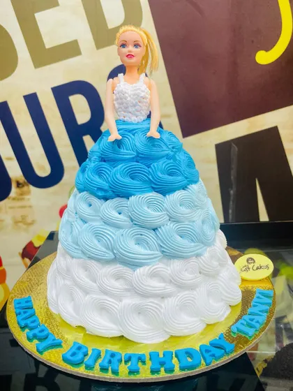 A classic 1.5kg Barbie doll cake, with the doll's dress made of beautiful blue and white buttercream rosettes.