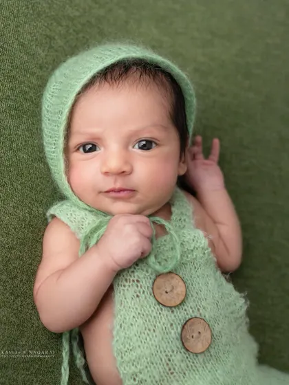 "Are you talking to me?" This nine-day-old's direct gaze and funny expression show that boss babies come in all sizes.