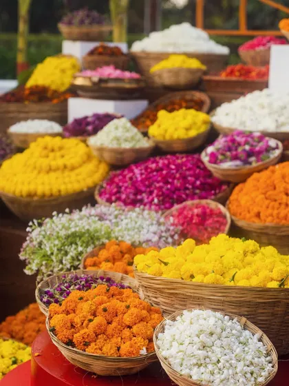 A beautiful setup for a flower shower, with a colorful array of fresh petals in wicker baskets, ready for guests to bless the happy couple.