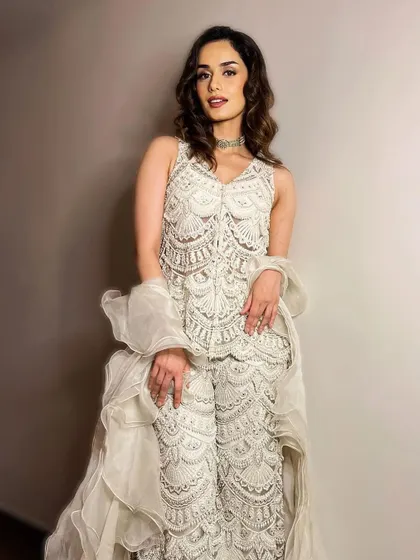 A vision in white. I styled Manushi Chhillar in this intricate white embroidered pantsuit with a ruffled dupatta. It's a chic, modern, and glamorous take on ethnic wear.