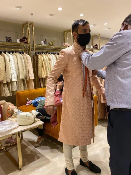 A glimpse of a groom's trial session. As a stylist, I am there for every fitting to ensure the sherwani is tailored to perfection for both comfort and style.