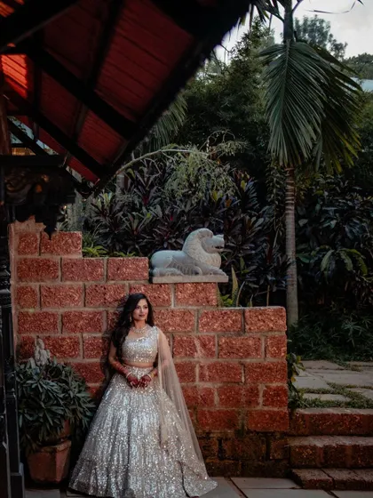 An elegant shot of the bride against the rustic brick and stone architecture of The Peacock Grove.