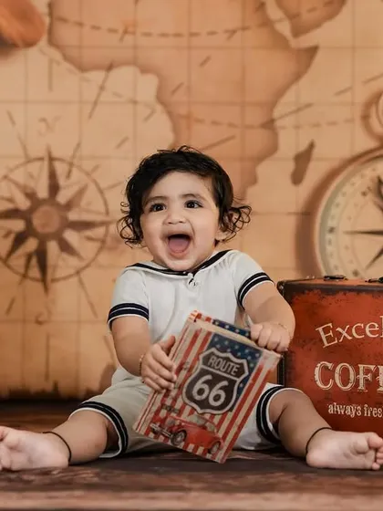 A joyful baby explorer in our travel-themed studio. His happy shout is the best part of this picture!