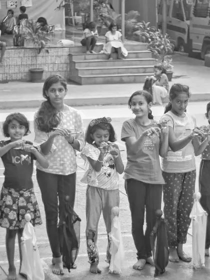 The concentration and fun of learning a new skill. These children are practicing how to make their puppets walk and move in unison.