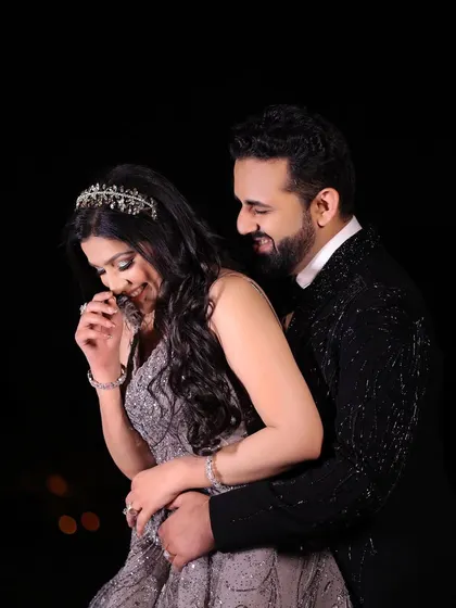 A candid moment of laughter and joy. This portrait captures the fun and playful side of the couple's relationship during their glamorous reception.