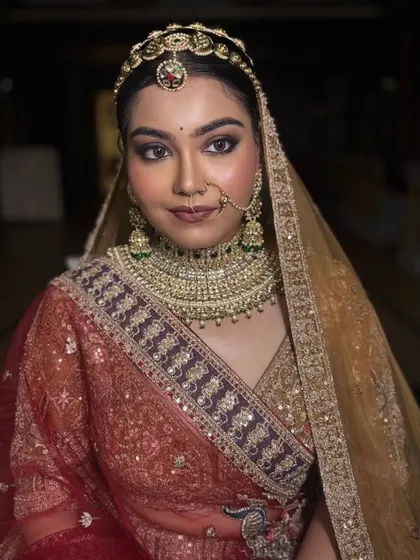 A powerful and direct portrait. The makeup is strong enough to be impactful while still letting her natural features shine through.