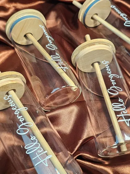 An overhead view of the glass tumblers, showing the bamboo lids and straws. These are great for wedding favors, corporate gifts, or as part of a curated hamper.