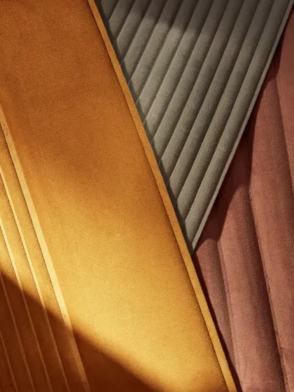 A composition of the 'Colonne' wallcovering in three different colorways. This shot showcases the versatility of the design and its ability to create different moods, from warm and earthy to cool and sophisticated.