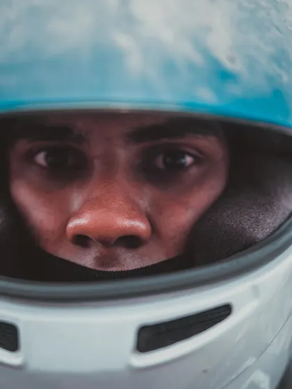 A close up of a driver's eyes in his helmet.
