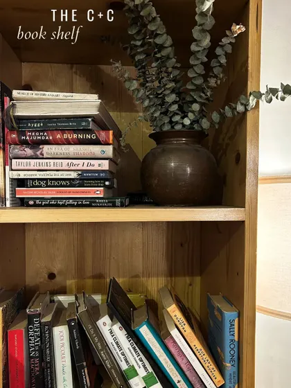 A glimpse of our book shelf, styled with dried eucalyptus. You'll find a mix of titles here, from books on mindful living like 'Hygge' to novels by our community members.