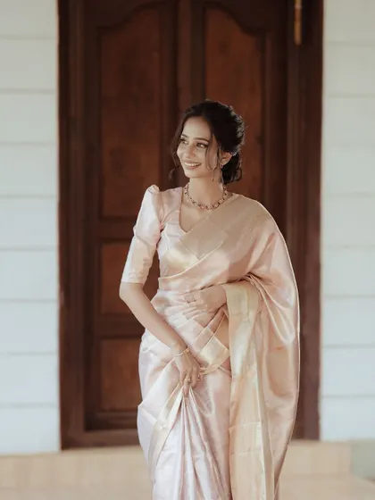 A duplicate of a full-length portrait of the bride in her elegant peach saree, her graceful posture and serene smile creating a timeless image.
