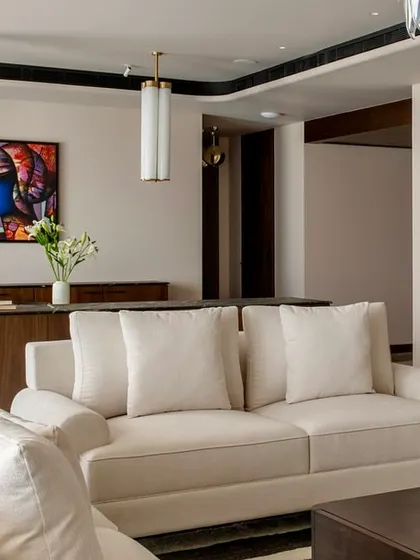 This shot highlights the open-plan nature of the Parishram residence, with a clear line of sight from the living room through to the dining area and beyond.