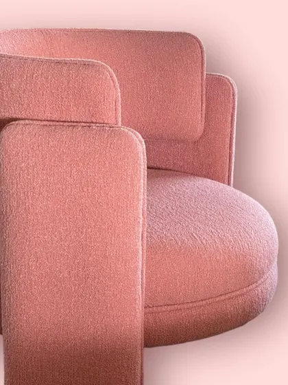 Another close-up of the "Pebble" chair, focusing on the intersection of the arm and backrest, showcasing its thoughtful design.