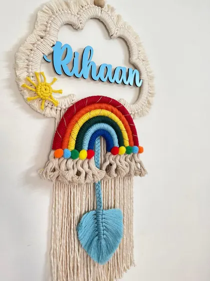 A classic rainbow dreamcatcher for 'Rihaan', featuring a blue macrame leaf to match his name. These make wonderful personalized gifts for baby showers and birthdays.