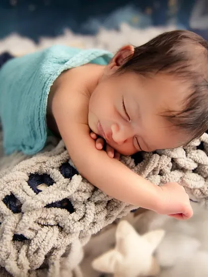 Lost in a world of dreams. A close-up shot like this, focusing on your baby's peaceful face, is a perfect goal for a simple and sweet mini session.