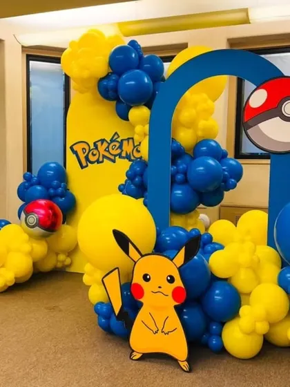Gotta catch 'em all! This vibrant Pokémon-themed backdrop is perfect for any fan, featuring Pikachu, Ash, a giant Pokéball, and bold blue and yellow balloon arrangements.