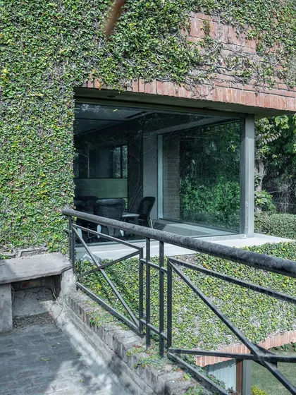 This project for a US-based international firm showcases my passion for biophilic design. The building's facade is covered in a living green wall, which not only creates a stunning visual but also improves air quality and connects the workspace with nature.