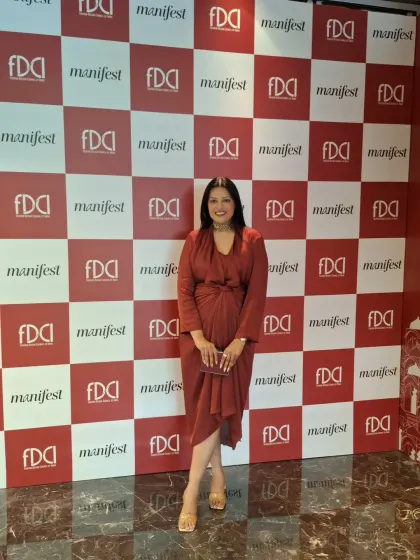 My look for the FDCI Wedding Weekend. This draped rust-colored dress offers a comfortable yet chic alternative to traditional wedding wear, perfect for a day of exploring designer collections.
