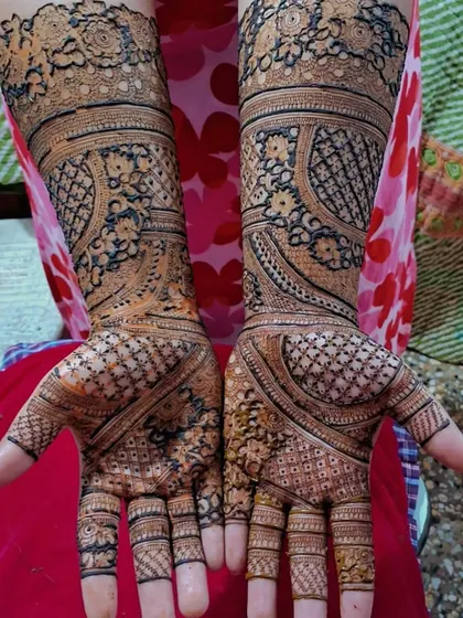 An intricate engagement mehendi design. The patterns are dense and detailed, covering the entire hand in a style that is rich and celebratory.