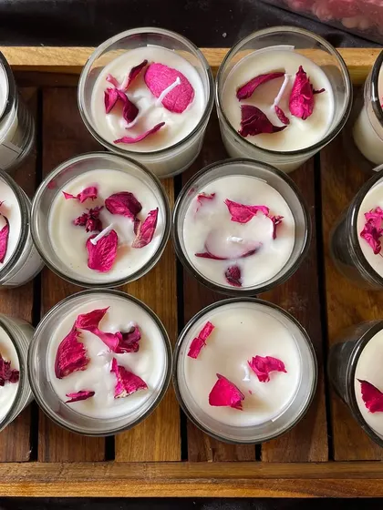A tray of freshly poured rose votive candles, ready for their labels and packaging.