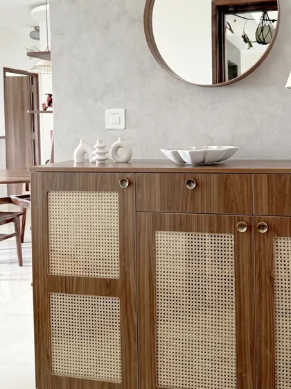 A closer view of the wooden and wicker foyer unit, highlighting the natural textures and simple, elegant hardware.