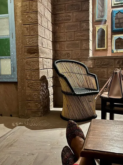 A quiet corner featuring a cane and bamboo chair, showcasing sustainable and traditional materials. This type of furniture is a great inspiration for my workshops, where we often work with natural and locally sourced items.