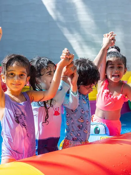 Friends celebrating together in the pool. Our water parties are a great way for kids to bond and have fun.