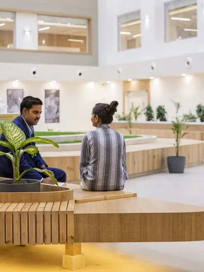 The central atrium at Paras Yash Kothari Hospital is a key feature of its adaptive reuse design. This space brings light and nature into the core of the building, with integrated seating and greenery creating a community-focussed healing garden.