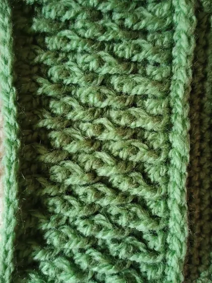 A close-up detail of the Alpine stitch used in the Sheldon beanie. This stitch is created using front post double crochets to make a dense, woven-like fabric.