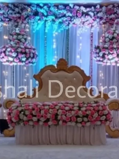 This is a classic and elegant wedding reception stage, always in high demand. The rental package includes the royal throne chair and matching sofas, a backdrop of white drapes with fairy lights, and beautiful hanging floral chandeliers.