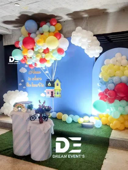 A full view of the 'Up' movie-themed housewarming decor, showing the creative use of balloons to create a floating house effect.