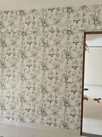 A living room with a delicate floral and butterfly wallpaper, adding a touch of whimsy and charm.