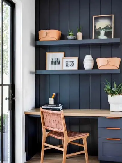 Color psychology plays a big role in our designs. A blue accent wall, as seen in this home office nook, is known to increase focus and productivity.