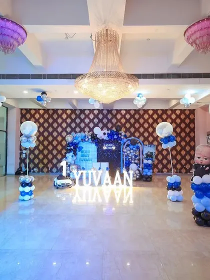 A full view of the "Boss Baby" party hall, with themed balloon pillars and character cutouts spread throughout the space.