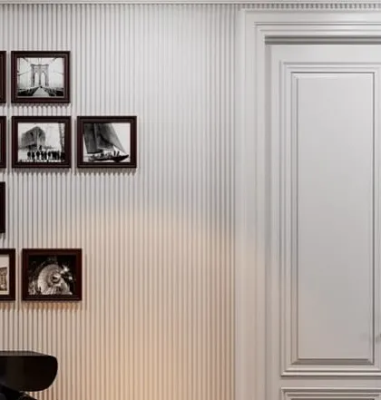 A detail of the gallery wall and the classic paneled doors. The clean lines of the wall and doors provide a perfect, neutral backdrop for the curated art collection.