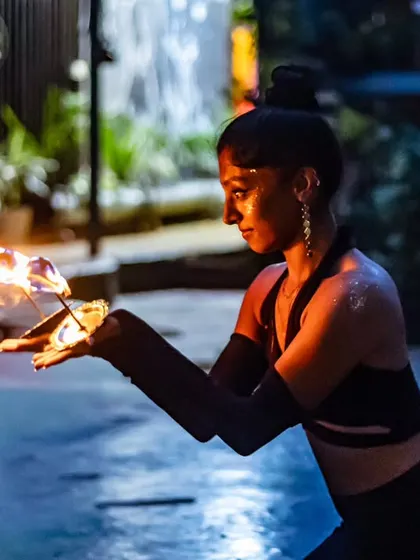 Kneeling with fire lamps, I feel grounded and powerful. Each movement in a fire performance is intentional, blending dance with the elemental force of fire for a captivating show.