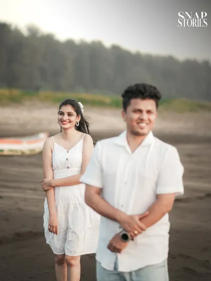 A creative shot using depth of field to focus on the bride-to-be while the groom is softly blurred in the foreground, adding an artistic touch to the pre-wedding photo.