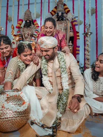 A joyous moment during a wedding game or ritual. The laughter and interaction between the couple and their family are what make these events so special.