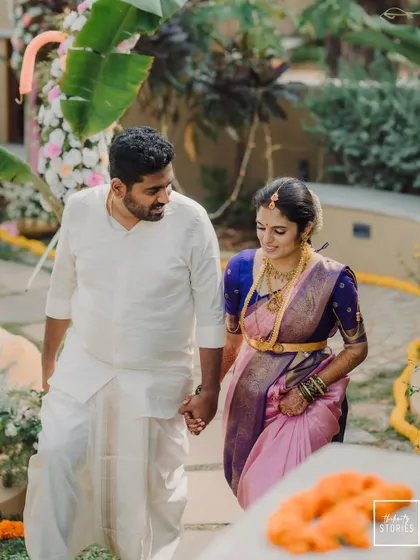 The couple walking hand-in-hand through their beautiful venue, a classic and timeless wedding portrait.
