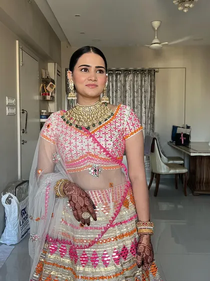 A full-length shot showing how the soft, blushed makeup works beautifully with the intricate, colourful outfit.