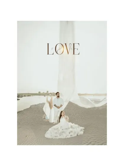 An artistic maternity portrait on a sandy shore, with the word "LOVE" elegantly overlaid. The flowing fabrics and serene landscape reflect the profound change and boundless love that motherhood brings.