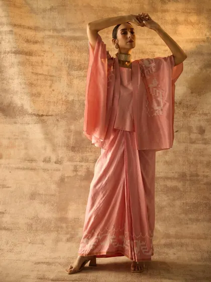 A soft pink ensemble featuring a draped jacket and matching trousers. My styling for this shoot focused on creating an ethereal, graceful look that highlights the delicate fabric and subtle print work.