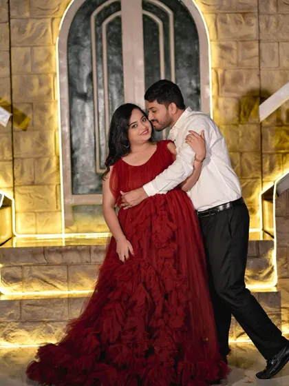 A tender moment on the stone staircase, with the warm lighting creating an intimate and romantic mood.
