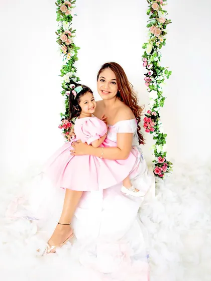 A mother's love in a single photo. This tender moment between a mother and her daughter on our floral swing is simply precious.