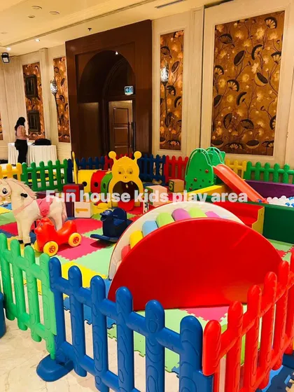 Our rainbow play area set up indoors, featuring the caterpillar tunnel, slide, and rocking horse.